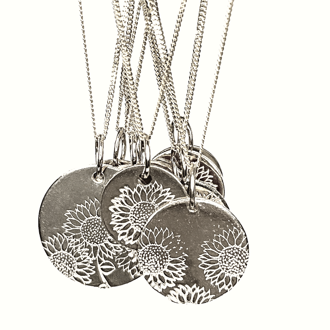 Sweet Sunflower necklaces in gold filled and sterling silver have been hand stamped with a sunflower metal stamp.  Each one is one of a kind and perfectly imperfect.