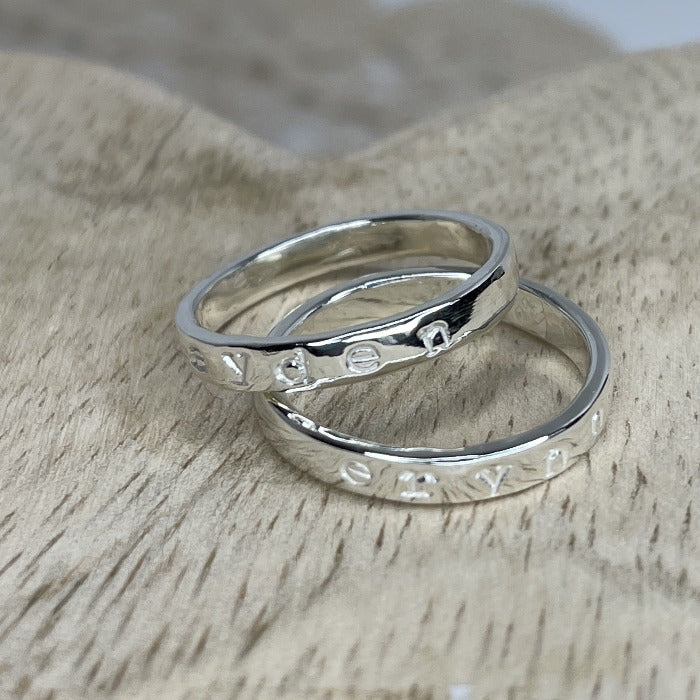 Two sterling silver Inspiration rings with kids name hand-stamped on the bands.  The names are not darkened