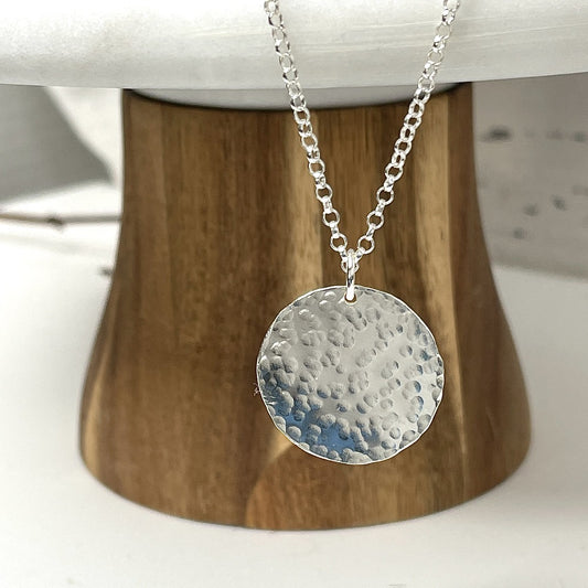 Hammered sterling silver round disk necklace on a long chain