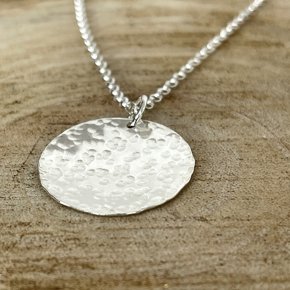 Hammered sterling silver round disk necklace on a long chain