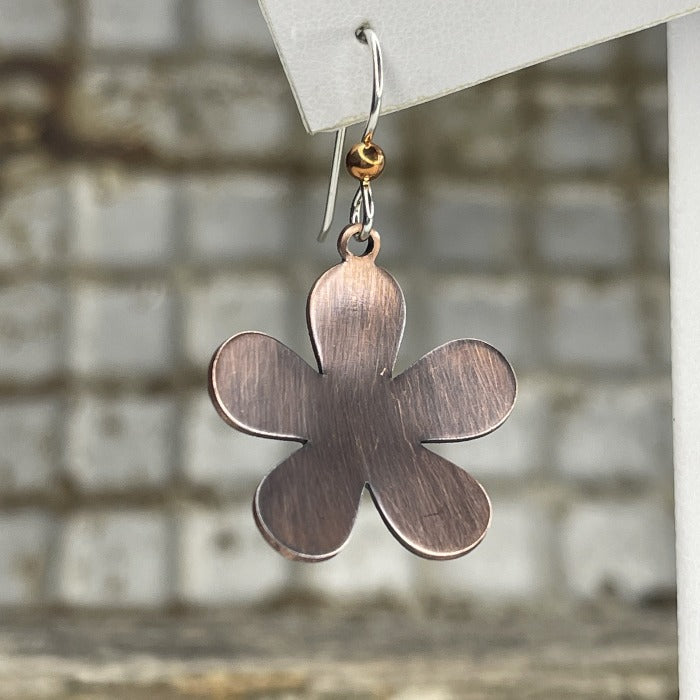Single Copper floral /daisy shaped earrings that have been oxidized, up close.  Each pair is slightly different.