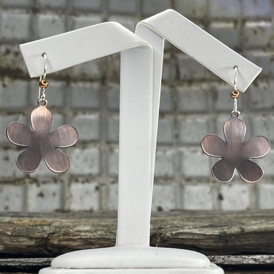 Copper floral /daisy shaped earrings that have been oxidized.  Each pair is slightly different.