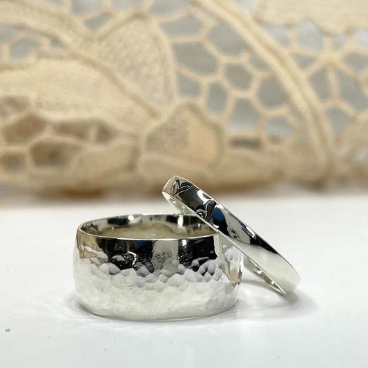 Textured Wide Band Sterling Ring, two sterling silver hammered rings laying on a white table with lace in the background